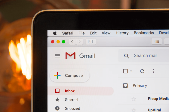 A Gmail tab is opened on a laptop.