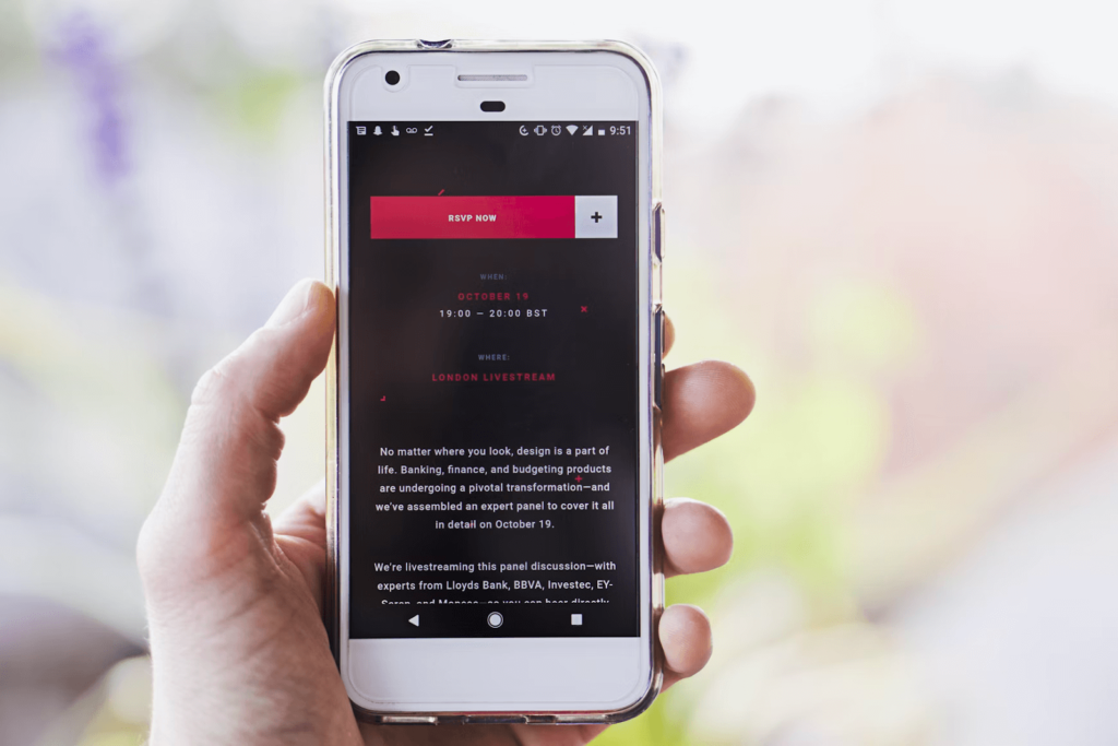 A man holds his phone with a nonprofit email fundraising appeal opened.