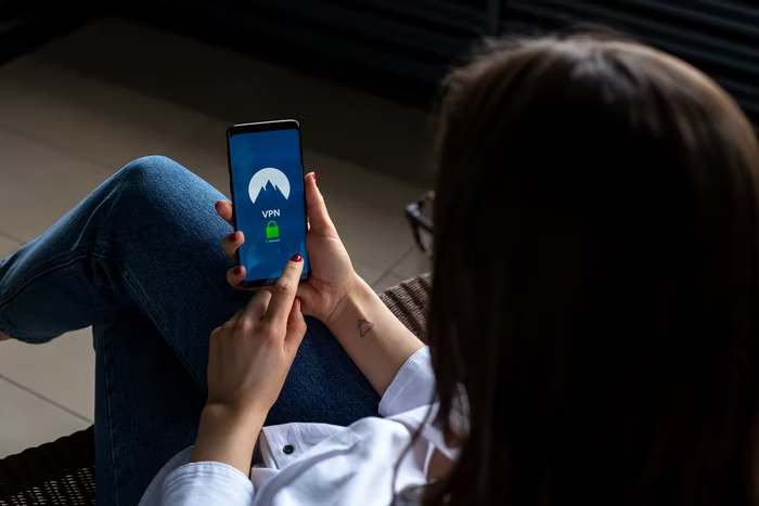 A nonprofit volunteer uses a secure device to log into her volunteer portal on her phone.