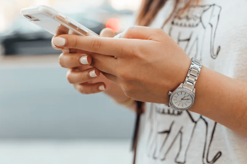 A young woman uses a mobile phone to give to a nonprofit organization.