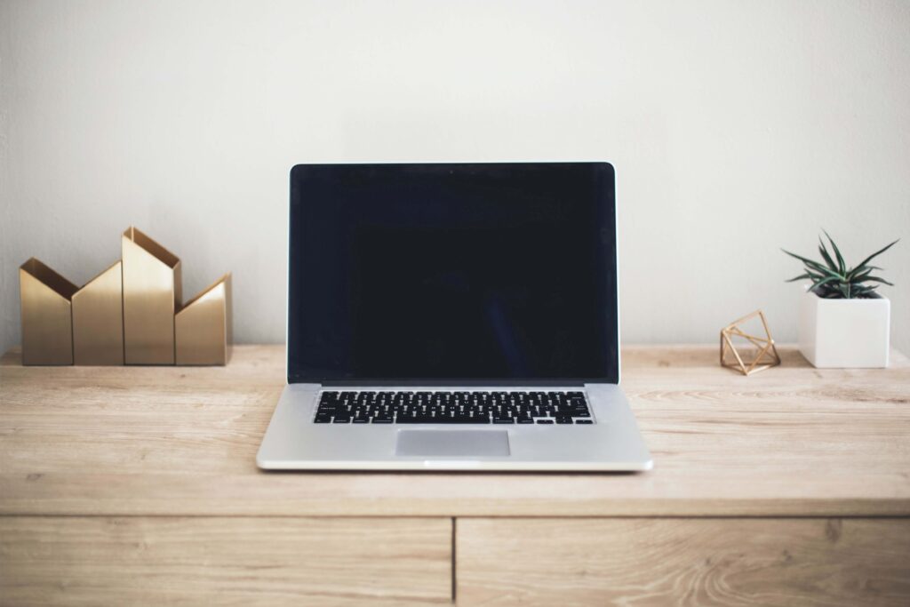 A laptop is opened on a wooden desk