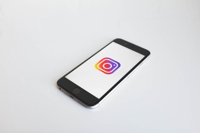 A smartphone is opened to the Instagram logo