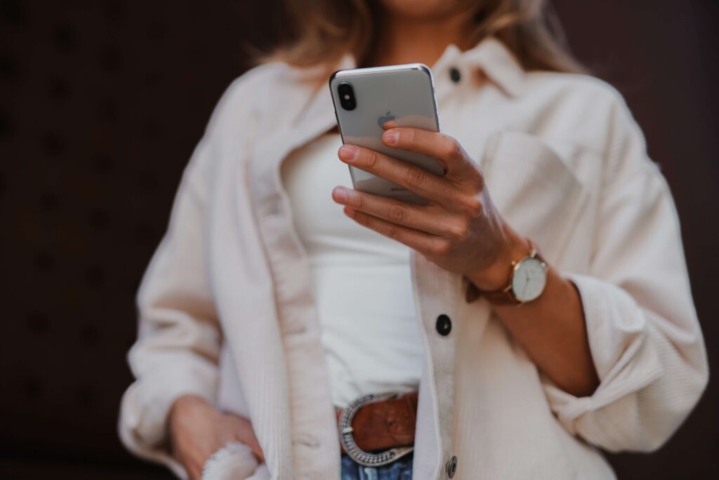 A woman holds her smartphone as she reads through a nonprofit’s email fundraising campaign