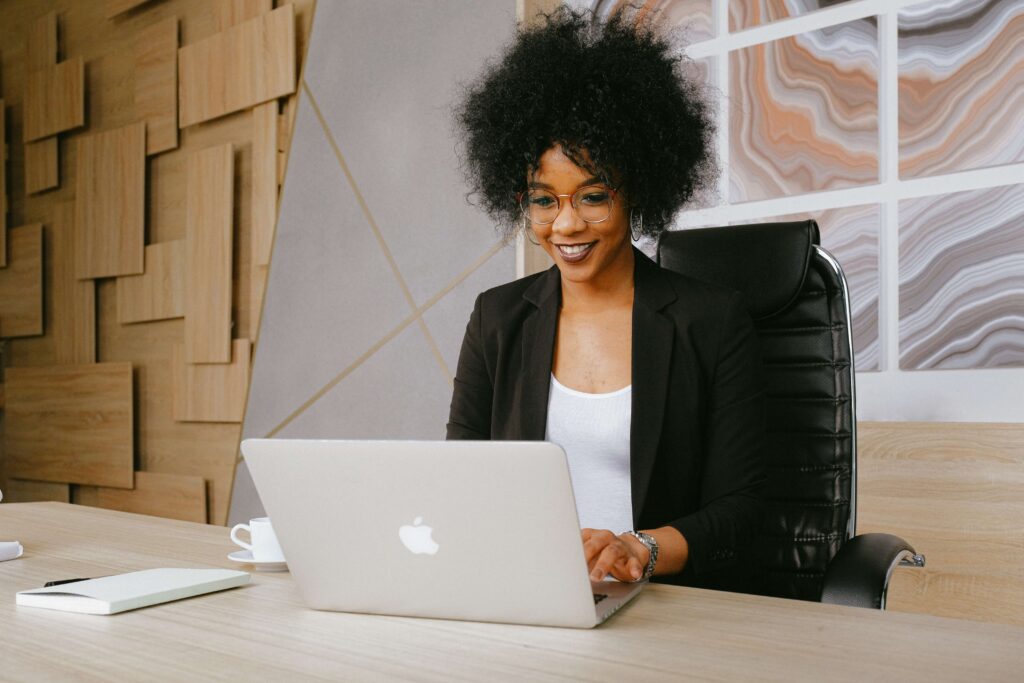 A young nonprofit professional sits at her laptop at the office