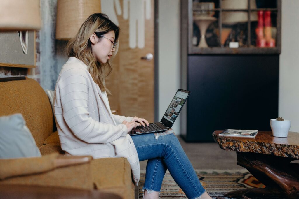 A young millennial supporter uses her laptop to make a donation for a nonprofit organization. 