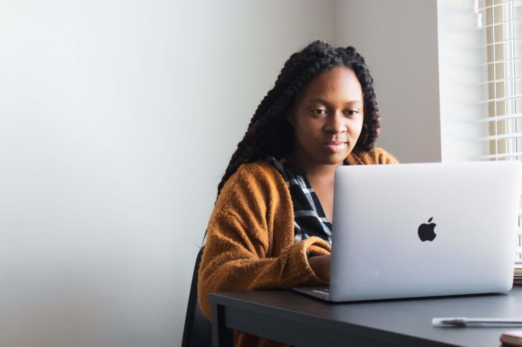 A woman uses a laptop for nonprofit blogging. 