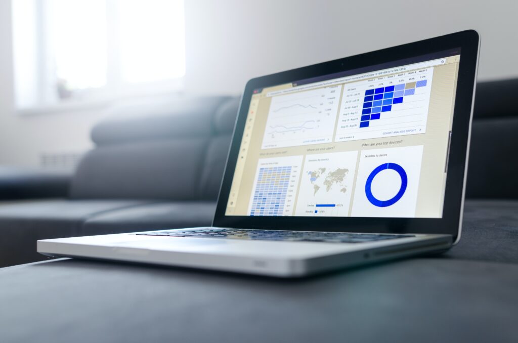 A laptop screen has data and feedback from nonprofit surveys. 