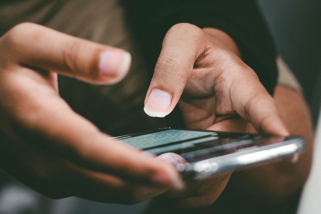 A person holds their smartphone as they reply back to a text to give for nonprofit campaign. 