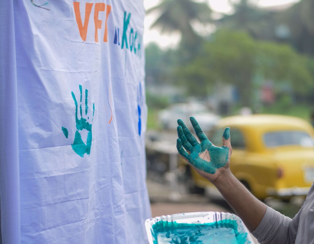 A volunteer helps create a flag celebrating the nonprofit's mission.