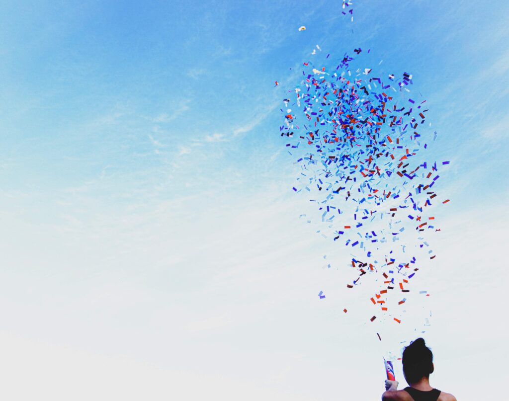 Confetti is thrown in the air after the launch of a charity sweepstakes. 