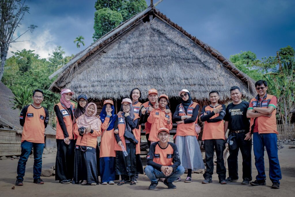 Volunteers stand together for a group photo after working with a nonprofit. 