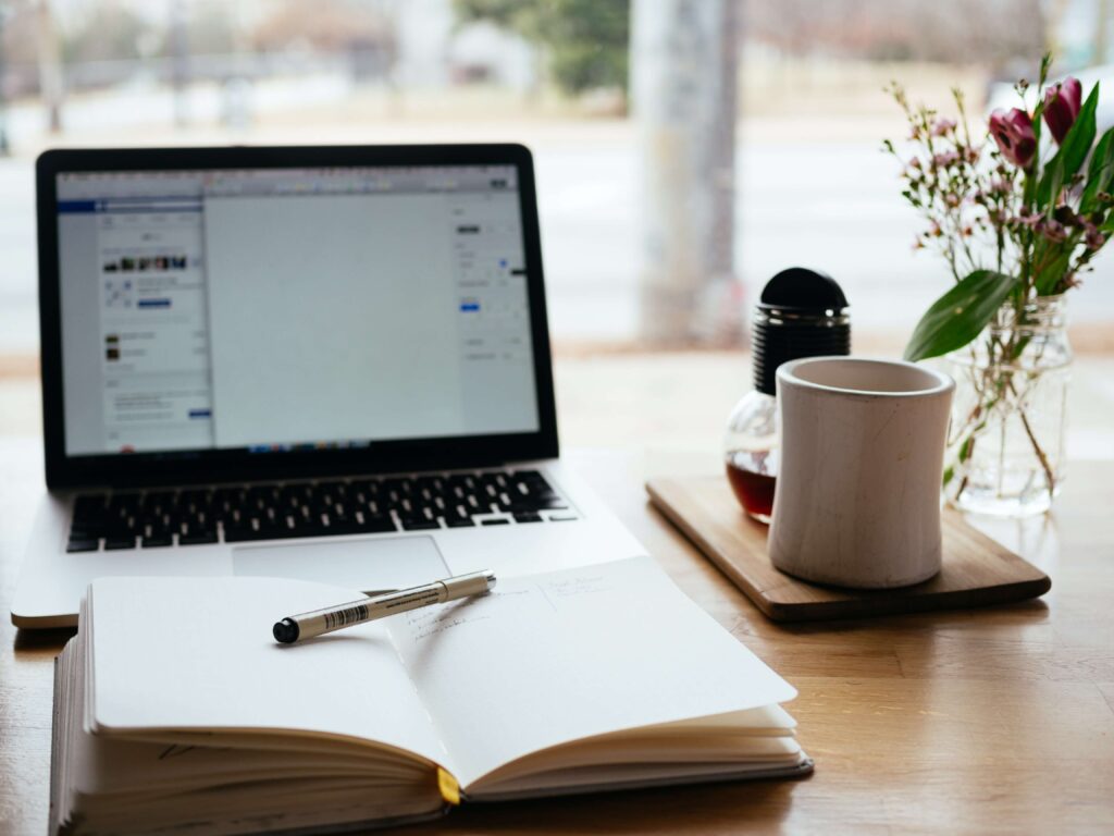 A laptop sits on a table with a learning management system for nonprofits pulled up on screen. 